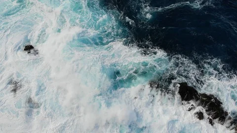 Waves of the Atlantic ocean beat against the rocky shore, black volcanic sand Stock Footage 102304855