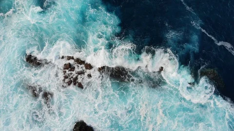 Waves of the Atlantic ocean beat against the rocky shore, black volcanic sand Stock Footage 102304957