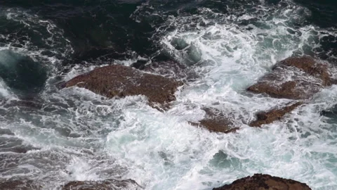 The waves of the Atlantic Ocean beat against the rocks Stock Footage 159299337