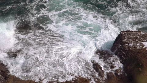 The waves of the Atlantic Ocean beat against the rocks Stock Footage 159299393