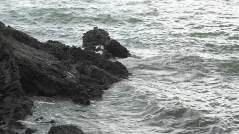 Waves attack to Black Rough Reef Rock Shallow Seashore Stock Footage 153506698