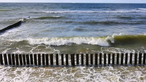 The waves of the baltic sea are breaking on the breakwaters, slow motion 4k Stock Footage 203878875