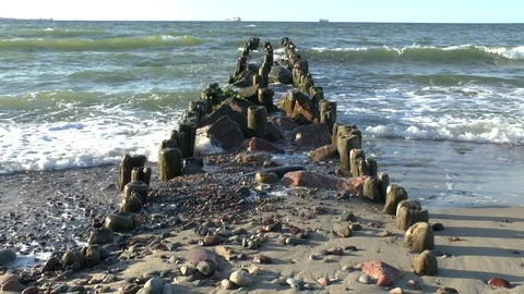 The waves of the Baltic sea break on an old wooden breakwater. Video Full HD Video stock 102238043