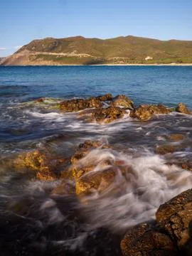 Waves bathing a rock Stock Photos
