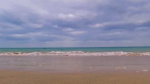 Waves, beach and dark cloudy sky at sunset Stock Footage 113052619