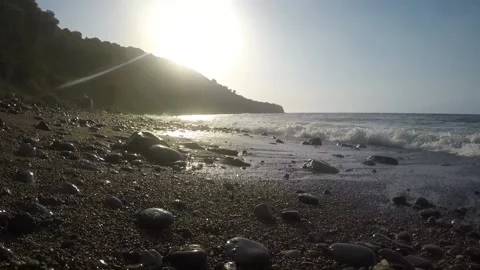 Waves on the beach around the time of sunset Video stock 148985059