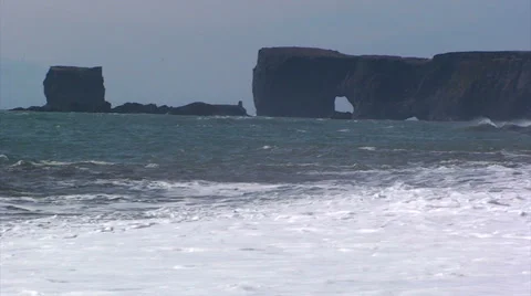 Waves on beach with background natural rock arch on shore Stock Footage 37580190