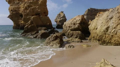 Waves on the beach between rocks on the southern coast of Portugal, Faro area. Stock Footage 251997292