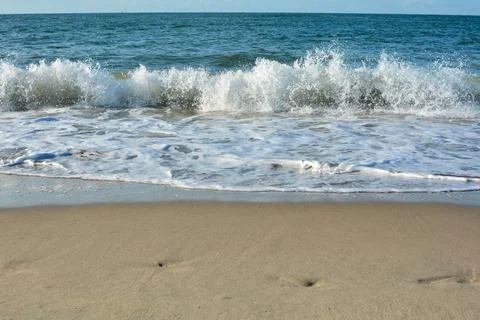 Waves on  beach with blue sky Stock Photos
