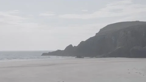 Waves on a beach with cliffs in background Stock Footage 159421327