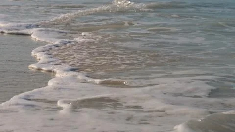 Waves on the beach at close range Stock Photos