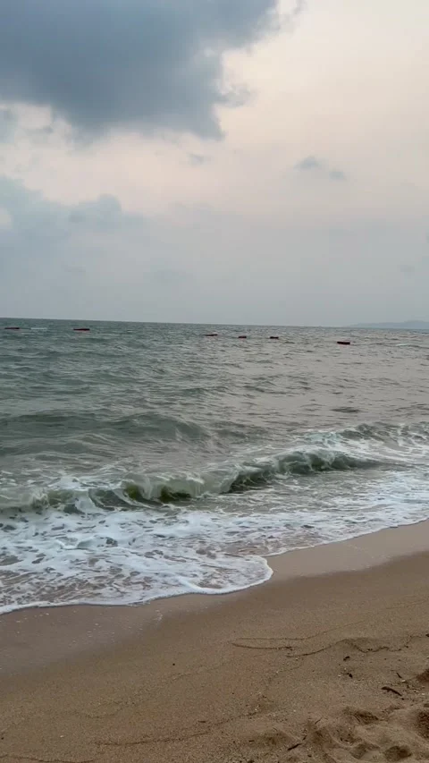 Waves on the beach on a cloudy day Stock Footage 237227638