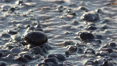 WAVES ON THE BEACH AT THE DAWN IN LIGURIA Stockbeeldmateriaal 100788829