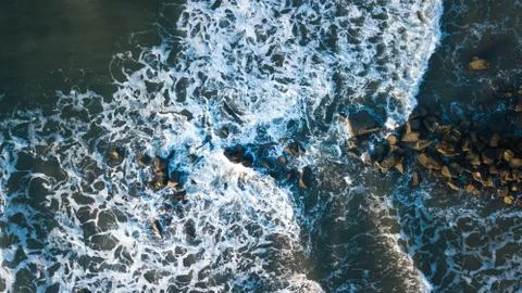 Waves on the beach, ocean meets rocks Stock Photos