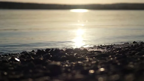 Waves On The Beach With Pebbles At Sunset, The Sun Goes Into The Water Stock Footage 157142167