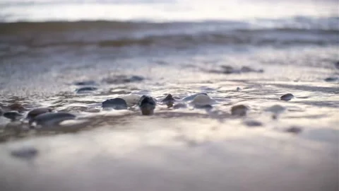 Waves On The Beach With Pebbles At Sunset, The Sun Goes Into The Water Stock Footage 157142176
