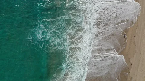 Waves on Beach with person walking Stock Footage 147515305