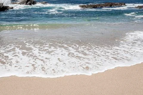 Waves at the beach. Stock Photos