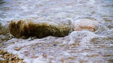 Waves on beach rocks Stock Footage 100666074