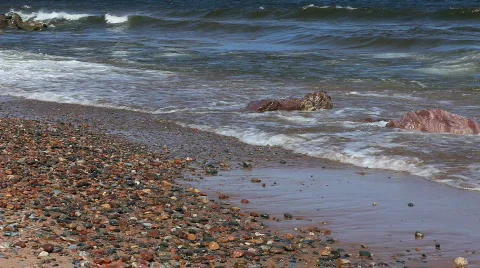 Waves on beach with small rocks Stock Footage 705132