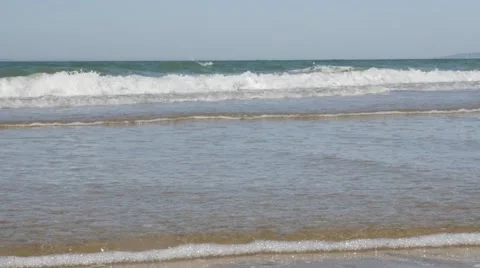 Waves on the beach spreading 4K 3840X2160 UltraHD footage -Blue sky and ocean Stock Footage 53202112