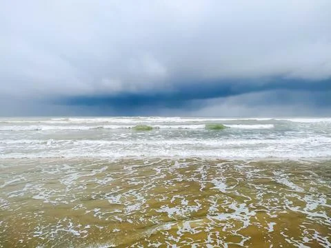 Waves on the beach in the storm sky Stock Photos