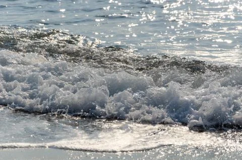 Waves on a beach at summer. Background for web pages and printing. Stock Photos
