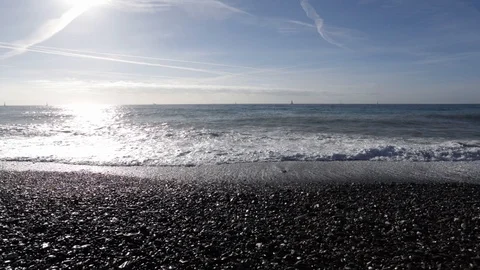 Waves on the beach in the sun with chemtrails Stock Footage 102651021