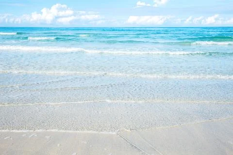 Waves on beach with sunlight. Stock Photos