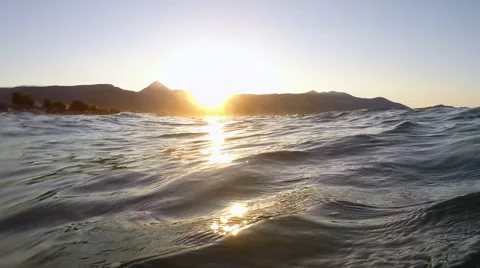Waves on a beach at sunset Stock Footage 48555527