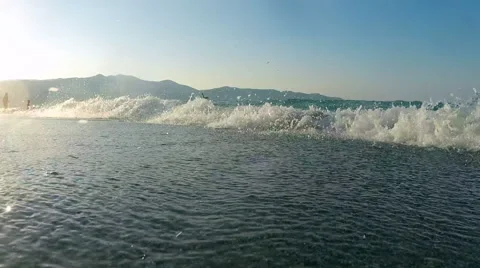 Waves on a beach at sunset Video stock 48718805