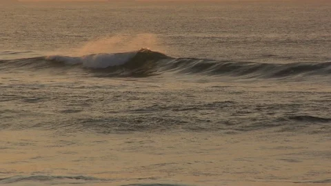 Waves on a beach at sunset Stockbeeldmateriaal 89027257