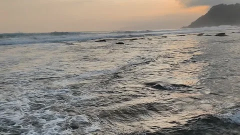 Waves on the beach at sunset Stock Footage 341662239