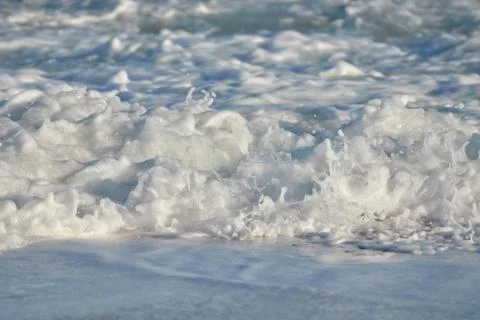 Waves on the beach in sunset light Foto stock