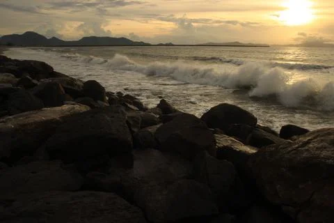 Waves on the beach at sunset Stock Photos