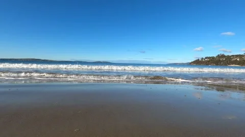 Waves on the beach in Tasmania, Australia moving towards the camera and then  Stock Footage 132481383