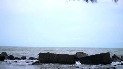 Waves on the beach with various rocks holding them back Stock Footage 262402239