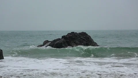 The waves beat against the rock Stock Footage 77508066
