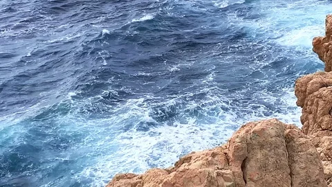Waves beat against rocks in a bay in Mallorca Stock Footage 114803904