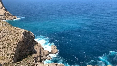 Waves beat against rocks in a bay in Mallorca Stockbeeldmateriaal 116236115