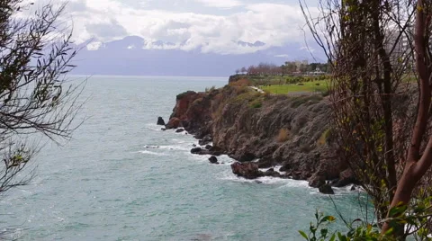 The waves beat against the rocks on the beach Stock Footage 64051769