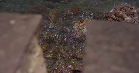 Waves beat against the rocks at sea. Slow Motion 120 fps. Small waves of the Video stock 78693150