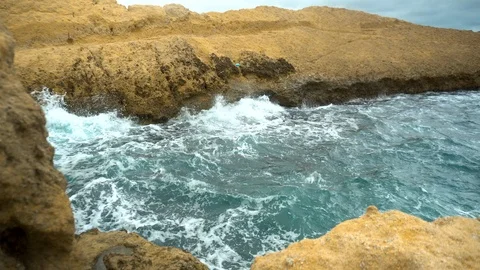 The waves beat against the rocks. Storm on the Mediterranean Sea. The sea is Stock Footage 120034390