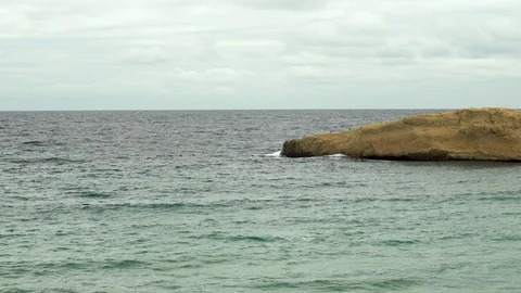 Waves beat against a rocky islet in the sea. Storm on the Mediterranean Sea. The Video stock 120030876