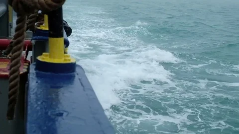 The waves beat against the side of the running ship Stock Footage 79811428