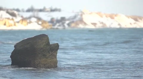 Waves beat against the stone. Slow motion. Stock Footage 52994399