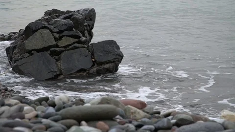 Waves beat on a rock by the sea Stock Footage