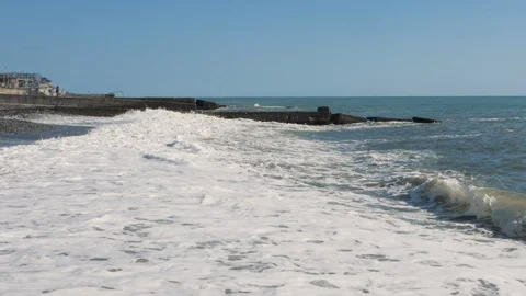 Waves beat on the shore in slow motion (long shot) Stockbeeldmateriaal 130083218