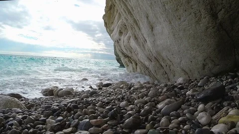 Waves beat into the stone beach Stock Footage 72075742