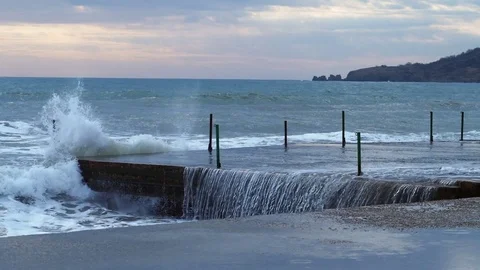 Waves beat on the stone promenade Stock Footage 84545702
